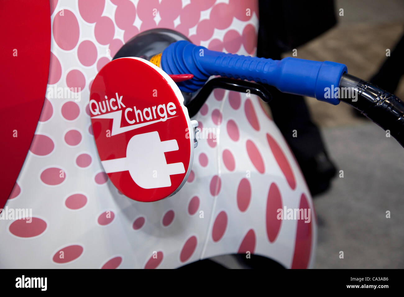 May 31st 2012, Tokyo, Japan. An electric car charging at the Smart Grid Exhibition and Automotive Next Industry Fair at Tokyo Big Site. The Fair shows the next generation of vehicles and manufacturing working with eco energy from 30th May to 1st June. Stock Photo