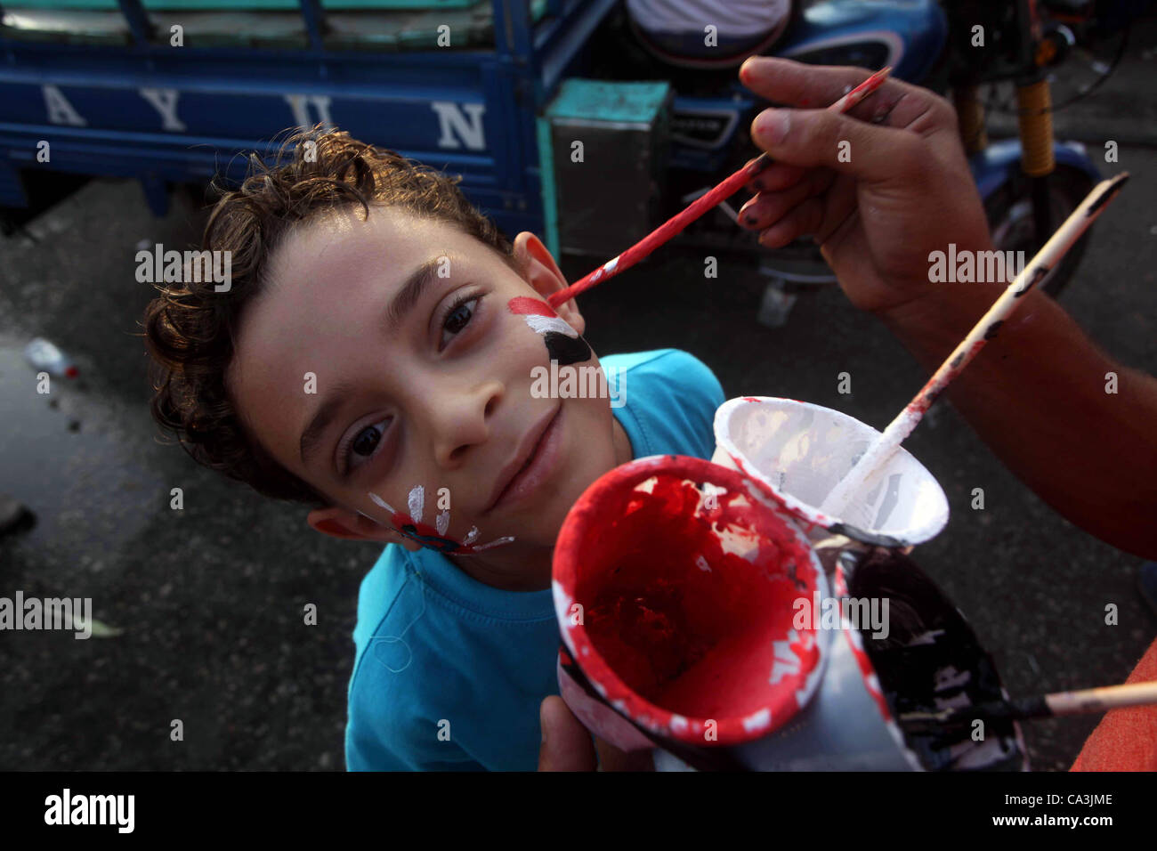 June 1, 2012 - Cairo, Cairo, Egypt - An Egyptian child draws national flag on face during a demonstration  against Egyptian presidential candidate Ahmed Shafiq in Tahrir Square decrying the result of the first round of voting in the Egyptian presidential election in Cairo, Egypt, Friday, June 1, 201 Stock Photo