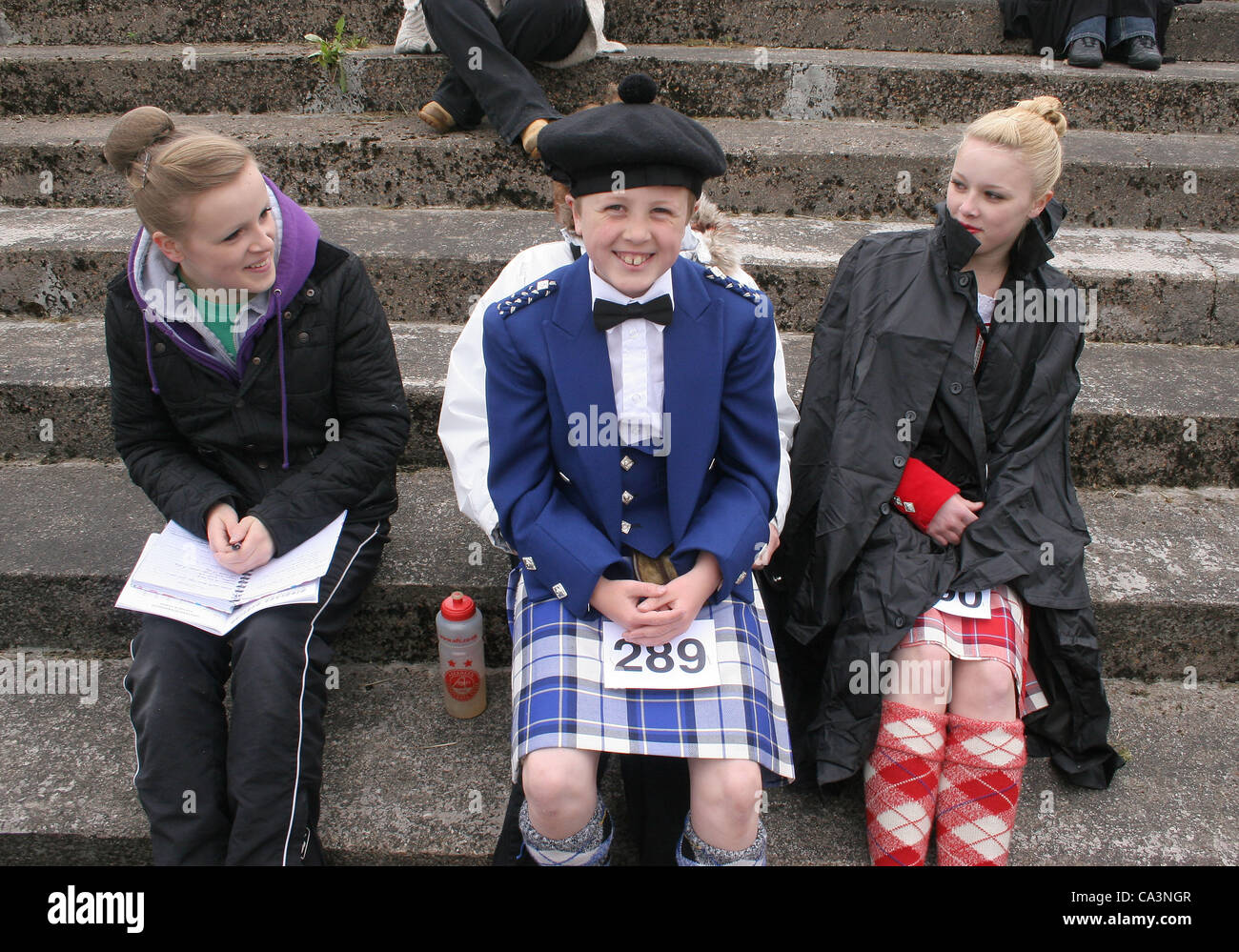 Shotts Highland Games. Shotts Scotland UK  02/06/12. Andrew Black aged 10 from Ellon in Aberdeenshire sitting on his mothers knee waiting for Highland Dance Contest. Stock Photo