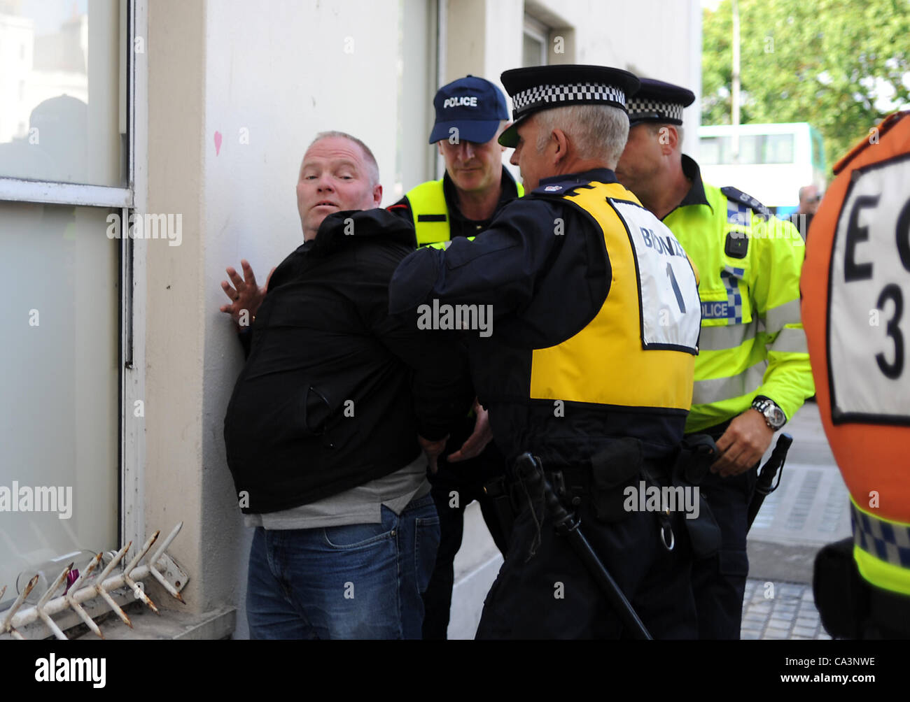 Brighton UK 2 June 2012 - Police move in to take away a man supporting the English Defence League in Brghton today . Stock Photo