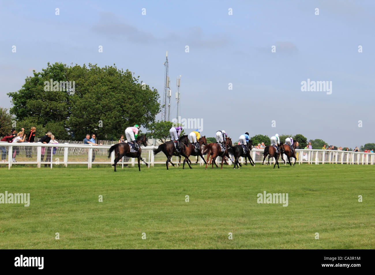 02/06/12. Epsom Downs, Surrey, UK. Horses and riders racing past the 8 furlong marker at The Derby 2012. Winner Camelot 2nd last. Stock Photo