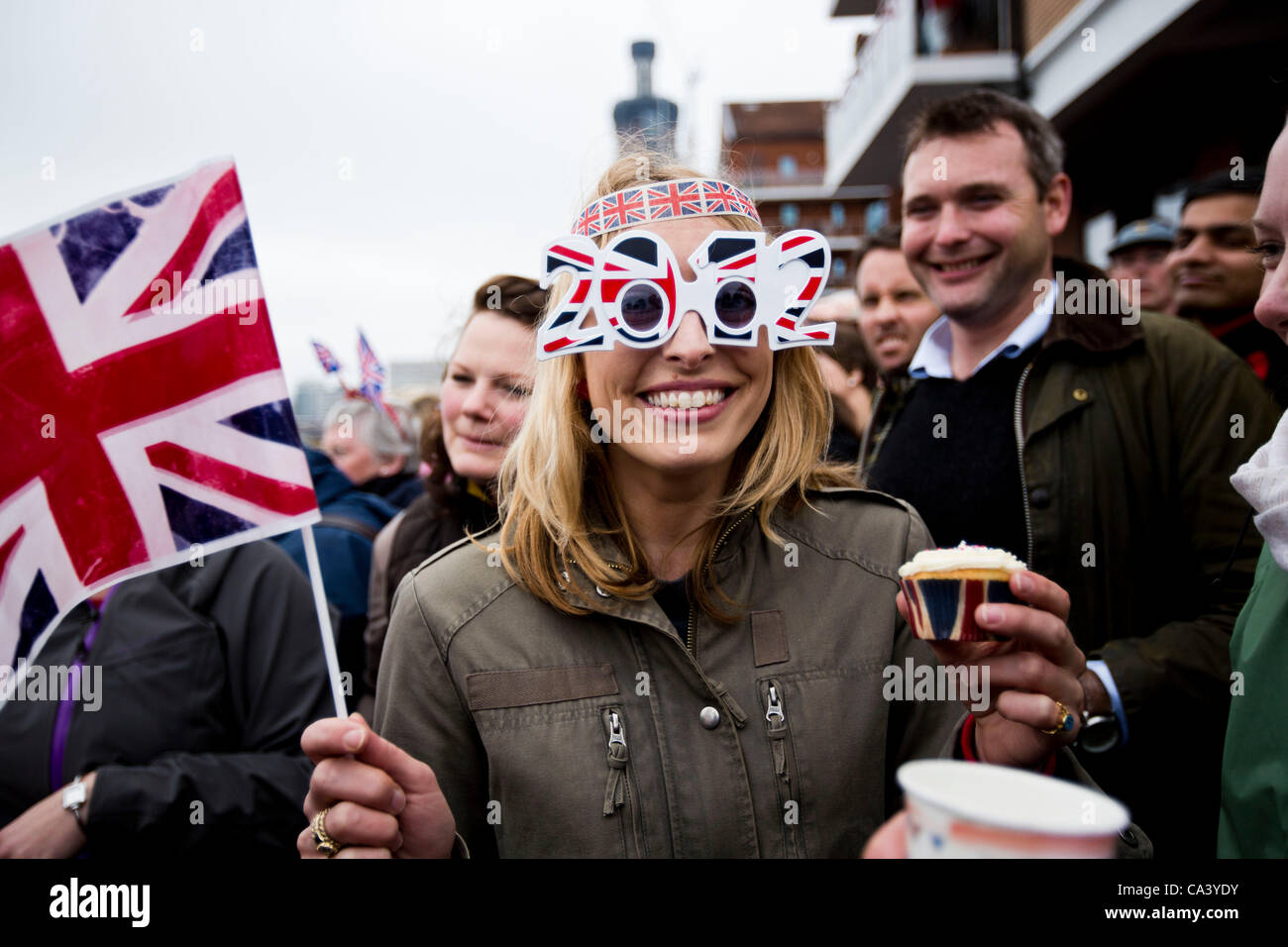 LONDON, UK, 3rd June 2012. Spectators enjoy their patriotic day waiting for Queen Elizabeth II to sail by. Stock Photo