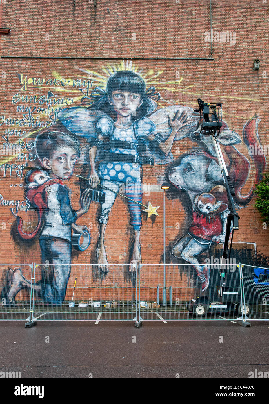 Graffiti display by graffiti artists Herakut with artists at work at