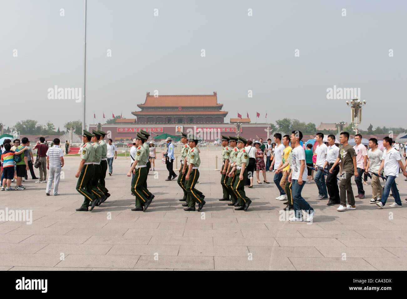 Military guards and plainclothes security officials marching on Tiananmen Square, Beijing, China on Monday June 4, 2012. Security is tight on Tiananmen square as June 4th 2012 marks the 23rd anniversary of the military crackdown on students protests at Tiananmen Square in 1989. Stock Photo