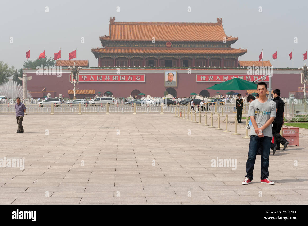 Plainclothes security official (right) on guard at Tiananmen Square, Beijing, China on Monday June 4, 2012. Security is tight on Tiananmen square as June 4th 2012 marks the 23rd anniversary of the military crackdown on students protests at Tiananmen Square in 1989. Stock Photo