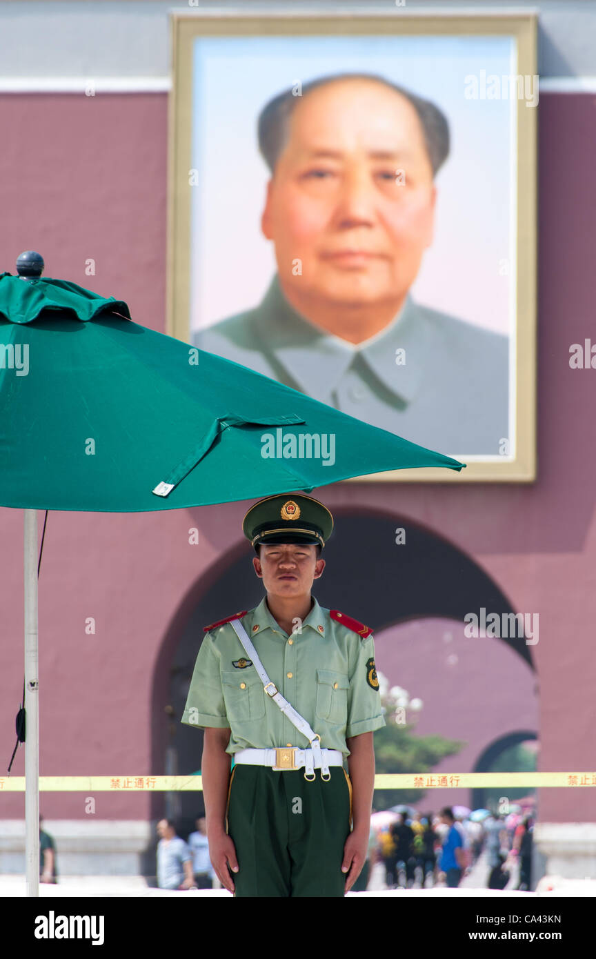 A military guard stands in front of Mao Zedong's portrait on Tiananmen Square, Beijing, China on Monday June 4, 2012. June 4th 2012 marks the 23rd anniversary of the military crackdown on students protests at Tiananmen Square in 1989. Stock Photo