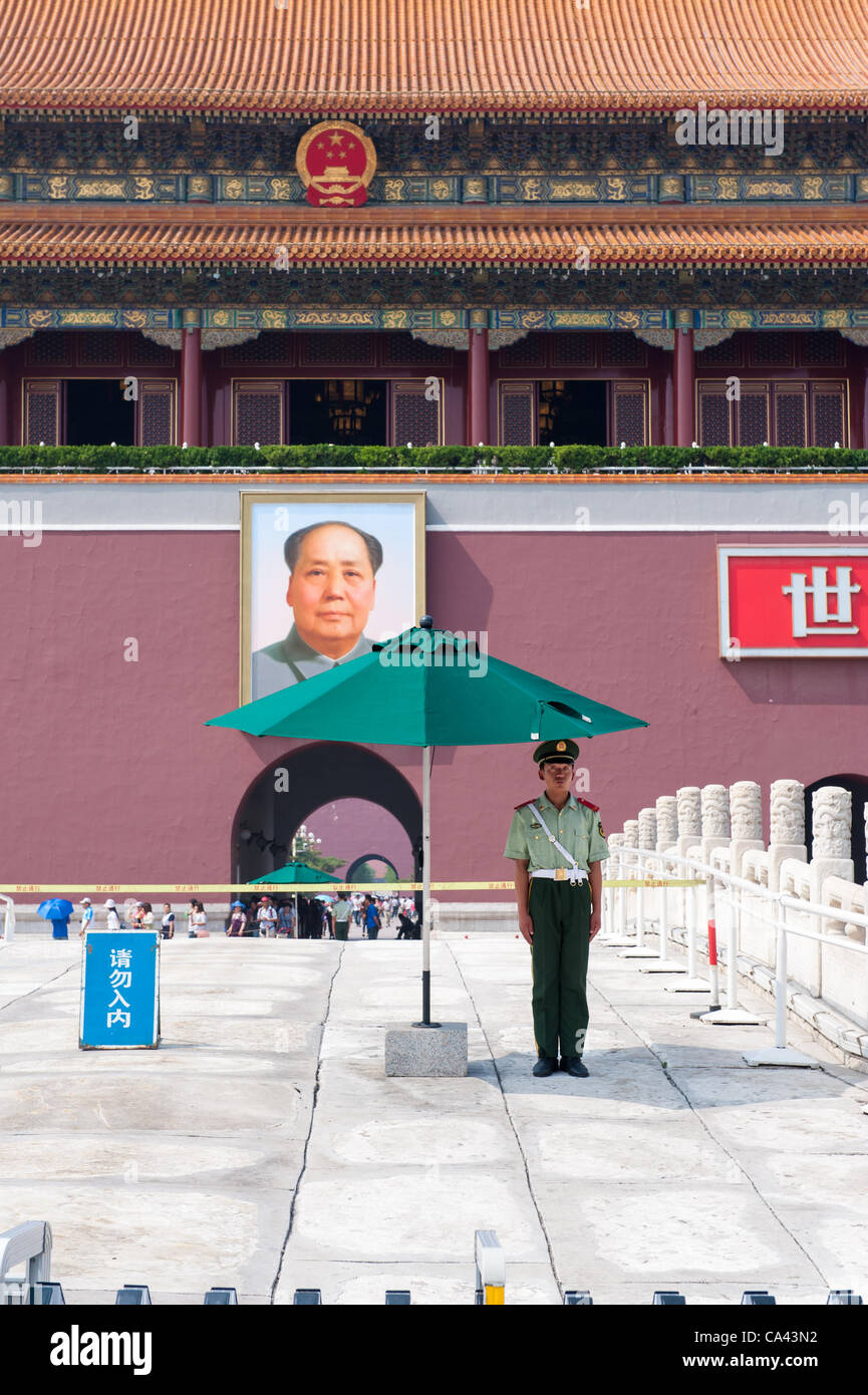 A military guard stands in front of Mao Zedong's portrait on Tiananmen Square, Beijing, China on Monday June 4, 2012. June 4th 2012 marks the 23rd anniversary of the military crackdown on students protests at Tiananmen Square in 1989. Stock Photo