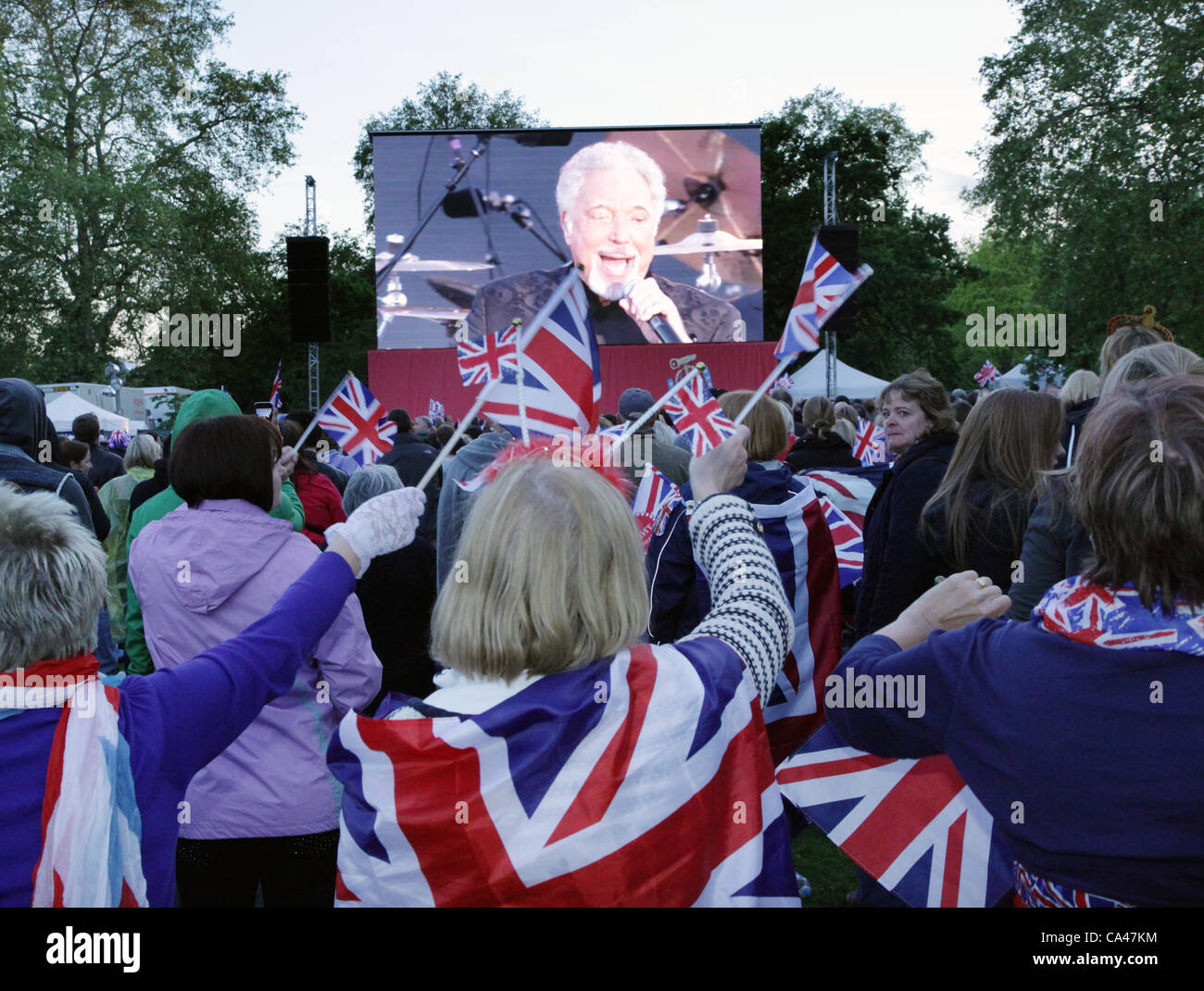 London, UK. June 4, 2012. Fans in London, enjoying Sir Tom Jones on the big screen in St. james Park Concert to celebrate The Queen's Diamond Jubilee. Stock Photo