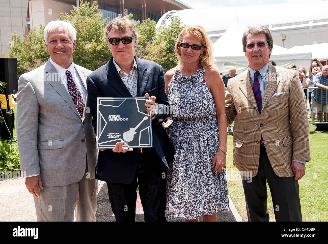 Jun 5, 2012 - Nashville, Tennessee; USA - (L-R) Dr. BOB FISHER Preseident of Belmont University, Musician STEVE WINWOOD,  EUGENIA WINWOOD and MARC STENGEL take part in the ceremony as Steve Winwood inducted into the Music City Walk of Fame that is located in Downtown Nashville.  Copyright 2012 Jason Stock Photo