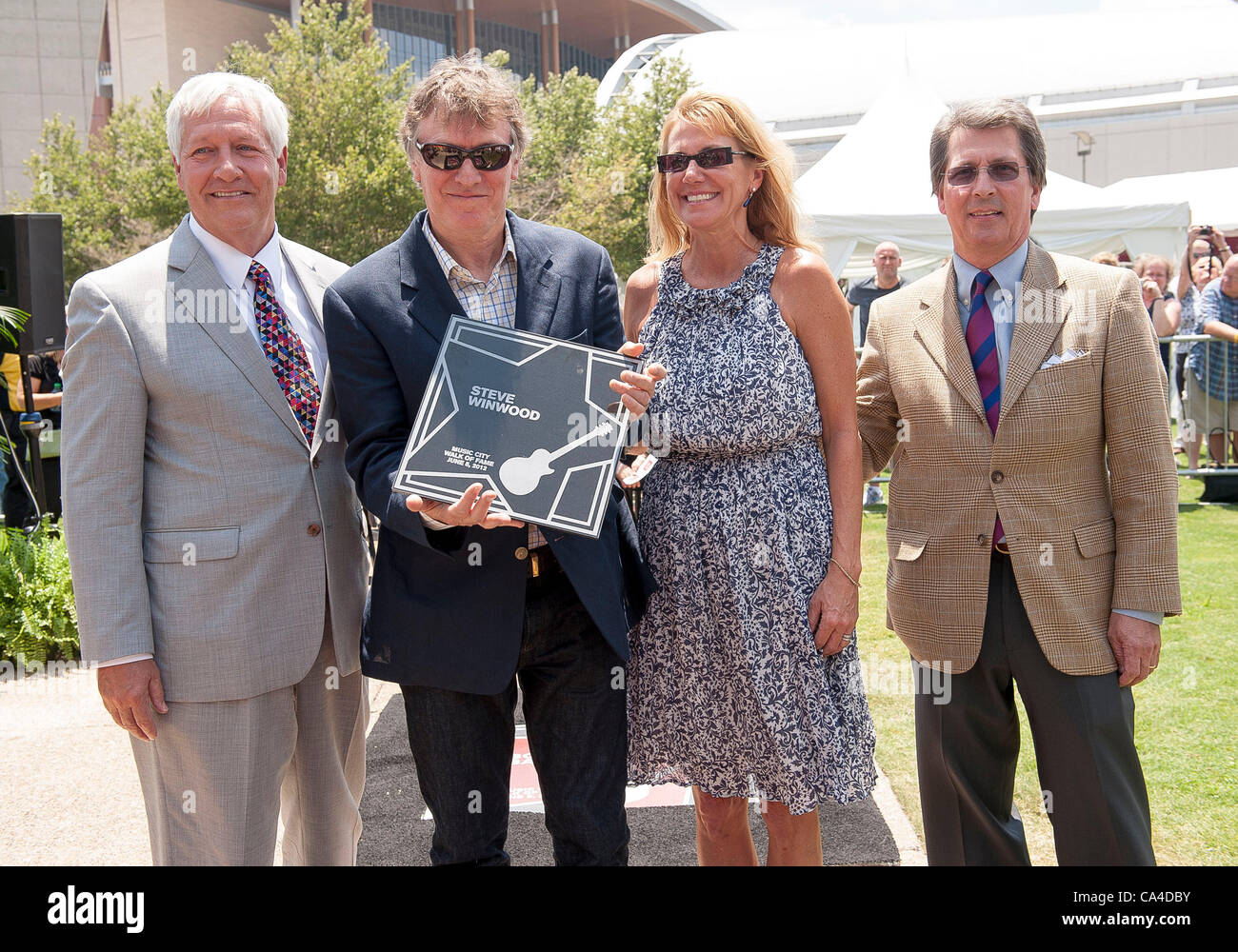 Jun 5, 2012 - Nashville, Tennessee; USA - (L-R) Dr. BOB FISHER Preseident of Belmont University, Musician STEVE WINWOOD,  EUGENIA WINWOOD and MARC STENGEL take part in the ceremony as Steve Winwood inducted into the Music City Walk of Fame that is located in Downtown Nashville.  Copyright 2012 Jason Stock Photo