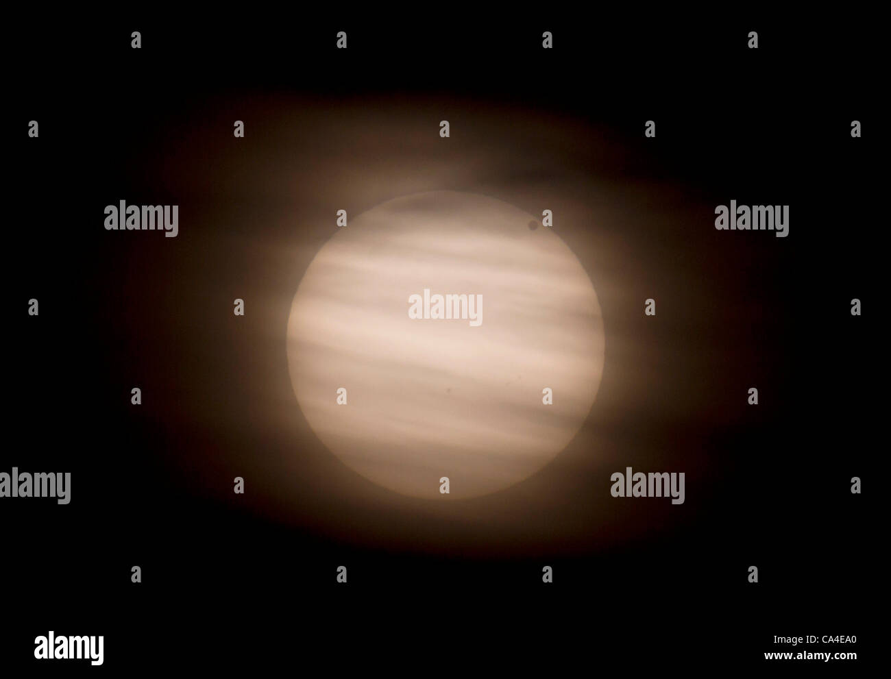 The transit of Venus across the Sun, seen through a gap in the clouds ...