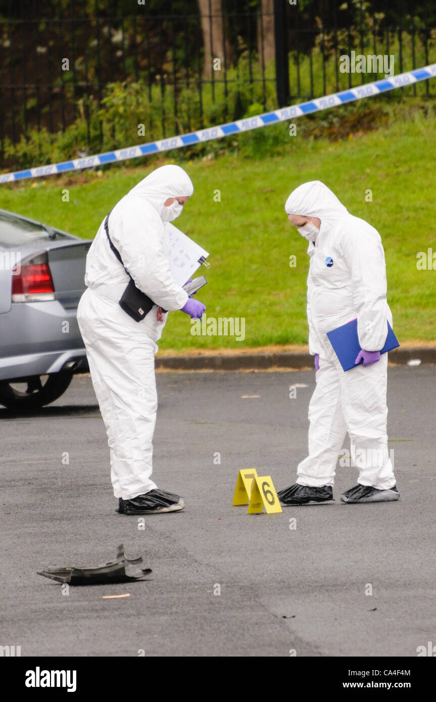 Scene of Crime officers collect evidence on a footpath after a pipe ...