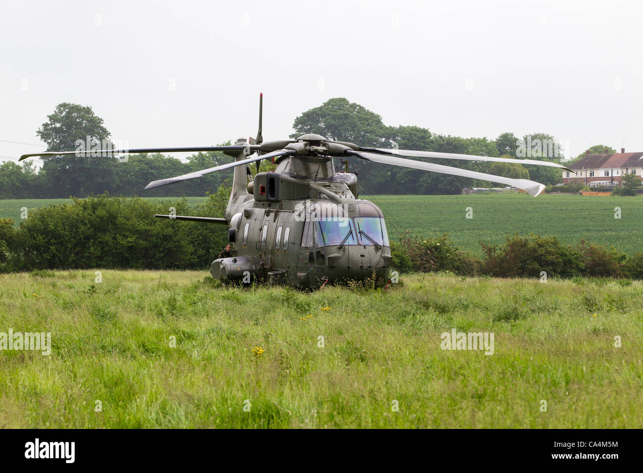 2012-06-07. Stanwick, Northamptonshire, UK. RAF Merlin mk3 helicopter grounded at a field in Stanwick on 06-06-2012 due to a loose panel near the rear rotor. After the repairs they hope to return to RAF Benson later this morning. Stock Photo