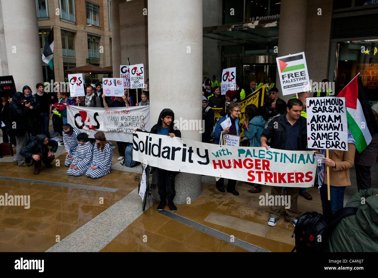 London, UK. 07th June 2012. Activists from different movements gathered outside  London Stock Exchange, Paternoster Square, London with signs where the private security company 'G4S' held the Annual General Meeting. Protesters accuse G4S of human rights abuse throughout the world Stock Photo