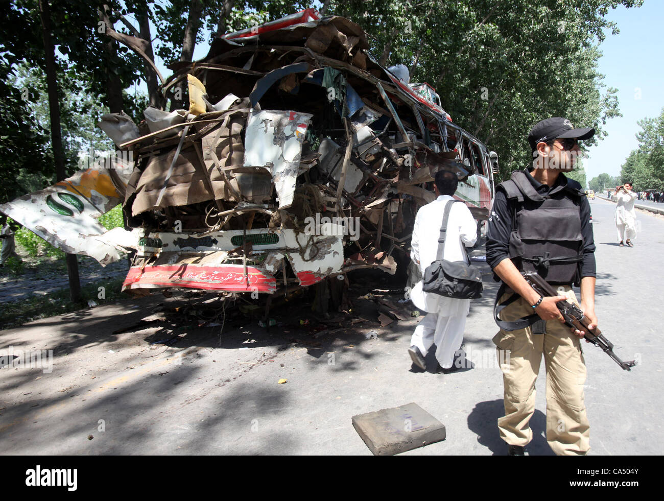 Wreckage of the affected bus located on Charsadda Road in Gulbela area after a bomb blast on Friday. At least 14 people have been killed thus far apart from several others being injured in Peshawar June 08, 2012 Stock Photo