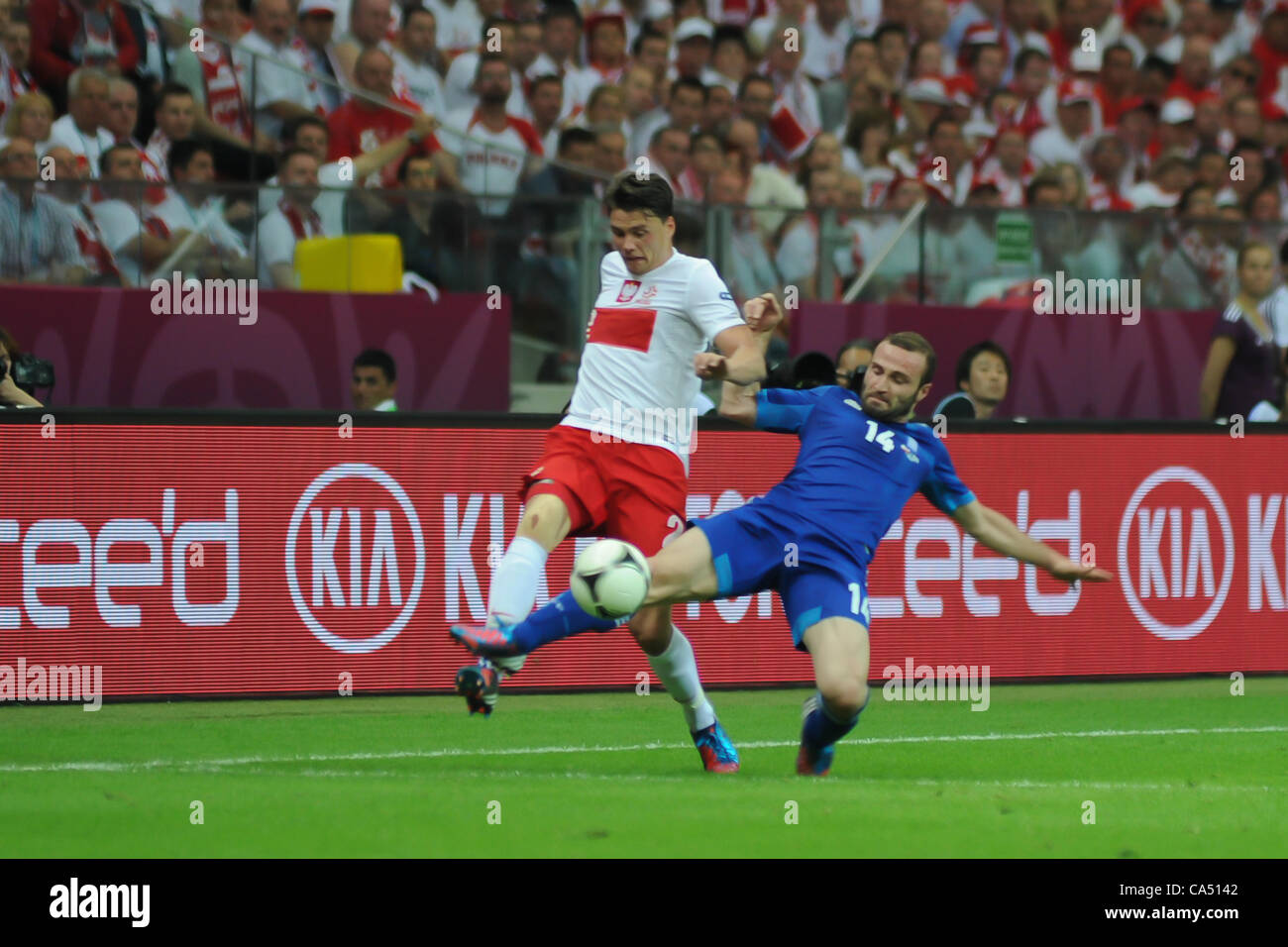 08.06.2012 Warsaw, Poland. Sebastian Boenisch (SV Werder Bremen) in action for Poland and Dimitris Salpingidis (PAOK FC) in action for Greece during the European Championship Group A game between Poland and Greece from the National Stadium. Stock Photo