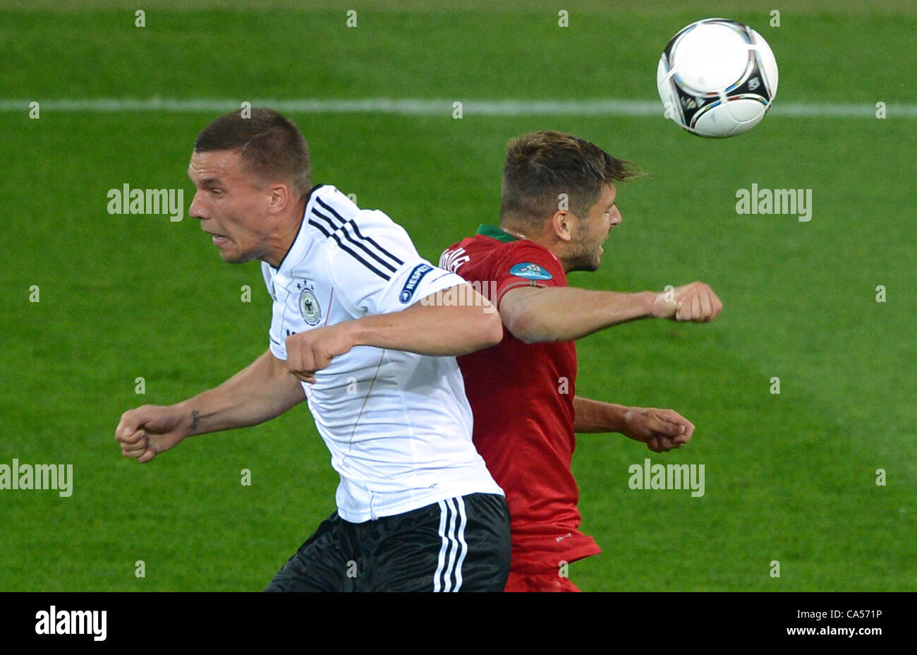 09.06.2012. Lvivi, Ukraine.  Germany's Lukas Podolski (L)and Portugal's Miguel Veloso challenge for the ball during UEFA EURO 2012 group B soccer match Germany vs Portugal at Arena Lviv in Lviv, the Ukraine, 09 June 2012. Stock Photo