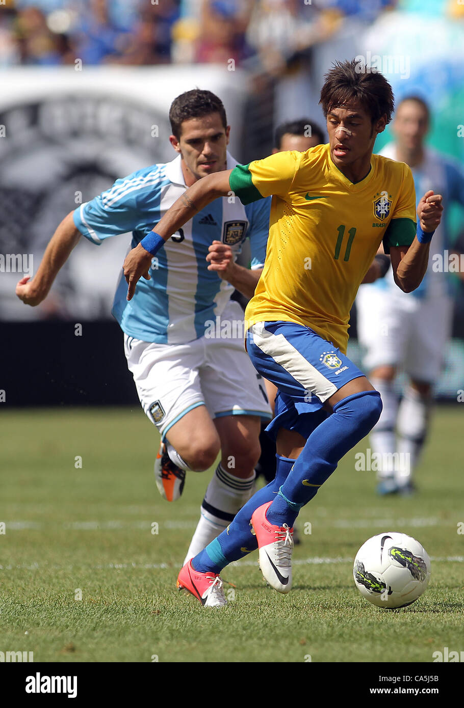 09.06.2012. New Jersey, USA. Fernando Gago (5) of Argentina chases after Neymar (11) of Brazil during an international friendly match at Metlife Stadium in East Rutherford,New Jersey. Argentina won 4-3. Stock Photo