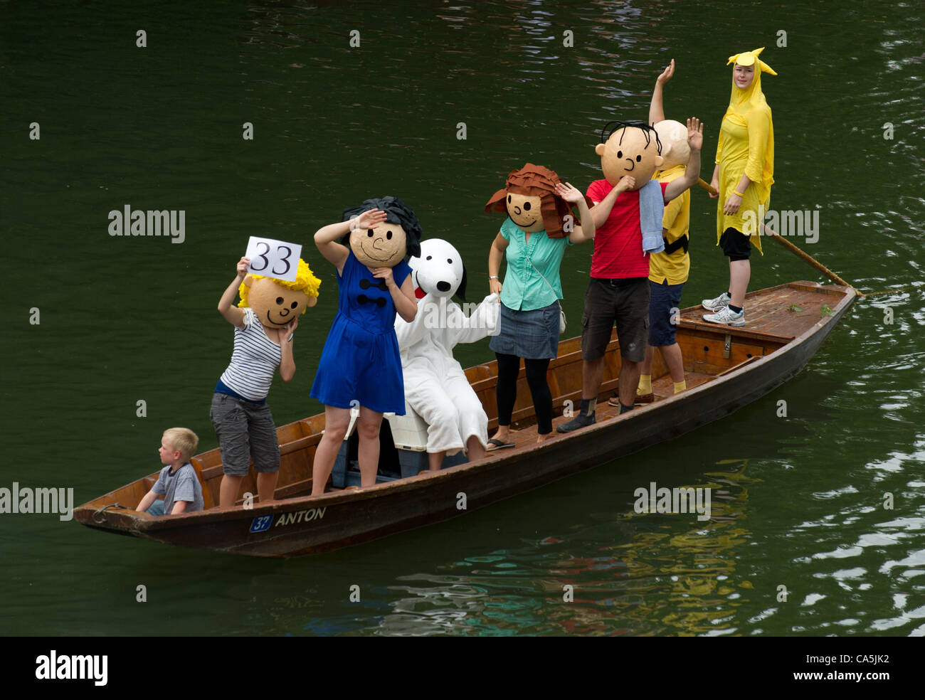 07.06.2012. Tuebingen, Germany.  People dressed as characters from the comic strip Peanuts take part in the fancy dress parade of the punt boat race (Stocherkahnrennen) on the river Neckar in tuebingen, Germany, 07 June 2012. Around 50 punt boats competed in this year's traditional punt boat race. Stock Photo