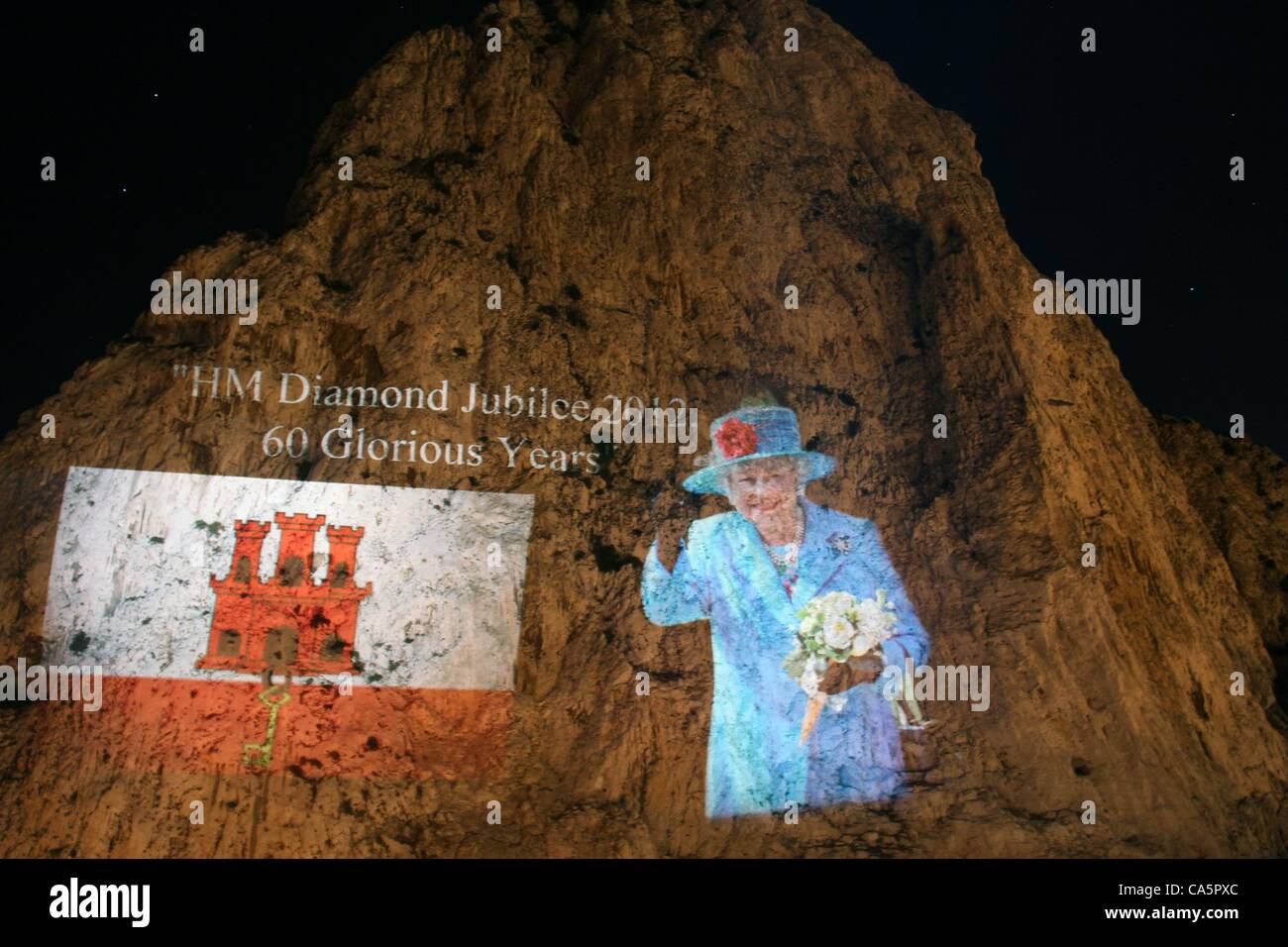 The Image's of Queen Elizabeth ll has be projected onto the northern front of the famous rock of Gibraltar.  The Union Jack and the Gibraltar Flag were also projected onto the rock itself.  It coincides with the jubilee celebrations for the queen large crowds of locals gathered to witness the moment Stock Photo
