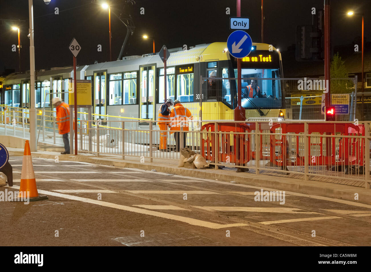 Wed 13th June 2012.  In the early hours of the morning a Manchester Metrolink tram makes the very first test run to Droylsden, Tameside, UK, on the street running section of the East Manchester Line.  The line is due to open to passenger traffic later this year. Stock Photo