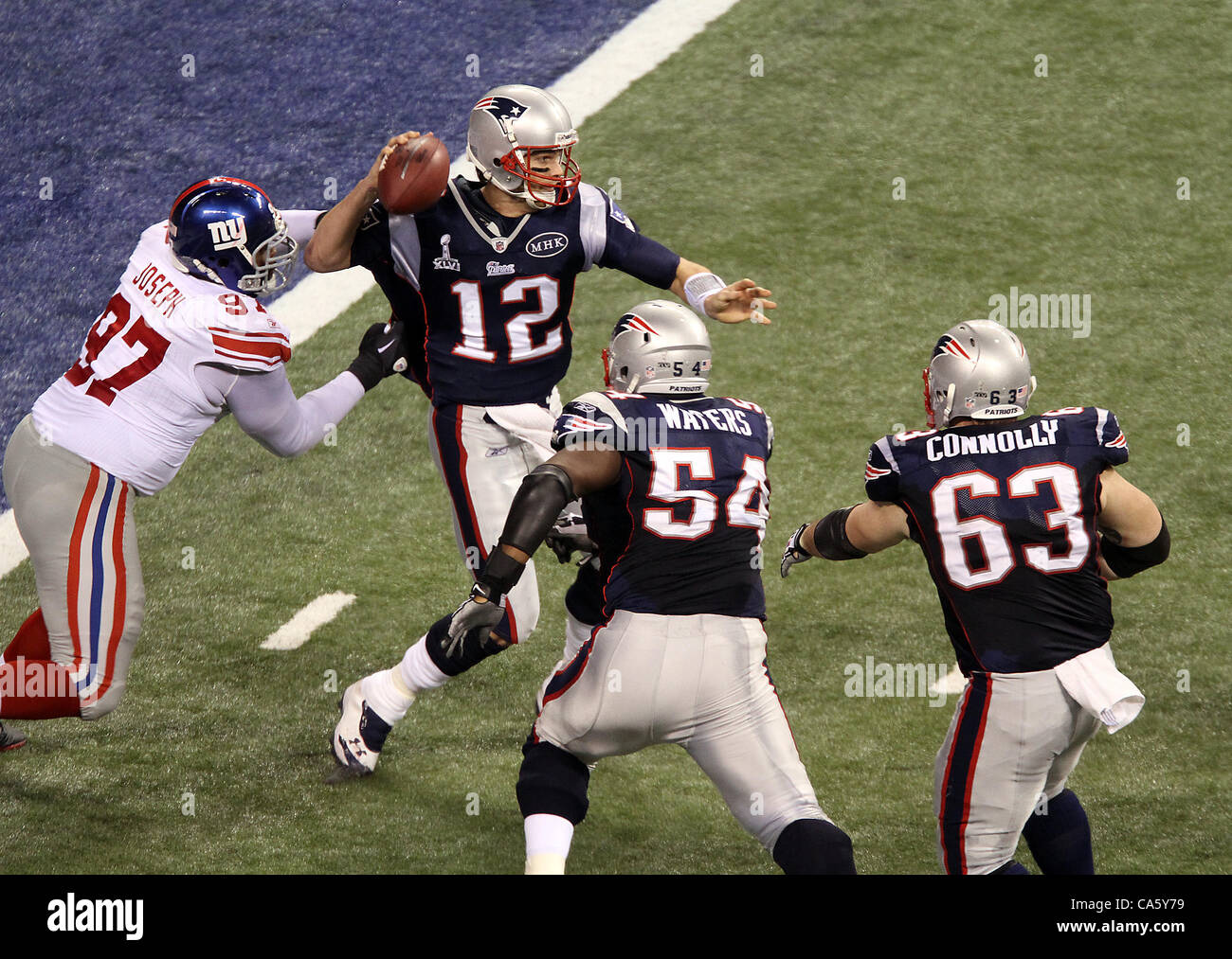 Feb. 5, 2012 - Indianapolis, IN, USA - New England Patriots quarterback Tom  Brady #12 gets pressured by New York Giants defensive tackle Linval Joseph  #97 during Super Bowl XLVI. Super Bowl