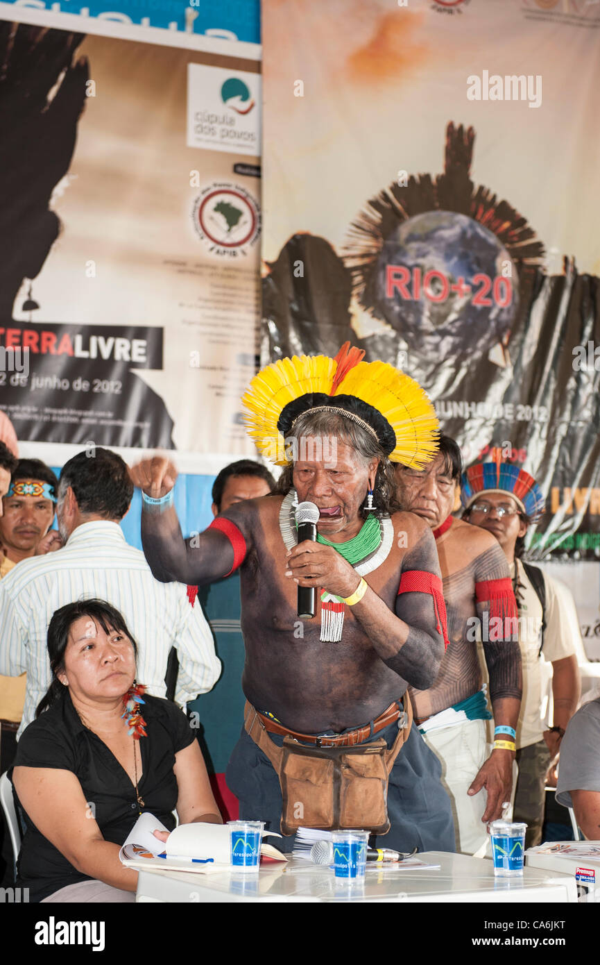 Kayapo Chief Raoni Txucarrhamae speaks to a packed audience about his people's opposition to the construction of hydroelectric dams, especially Belo Monte; to the left is indigenous lawyer Joenia Batista de Carvalho, a Wapichana Indian. The People's Summit at the United Nations Conference on Sustain Stock Photo