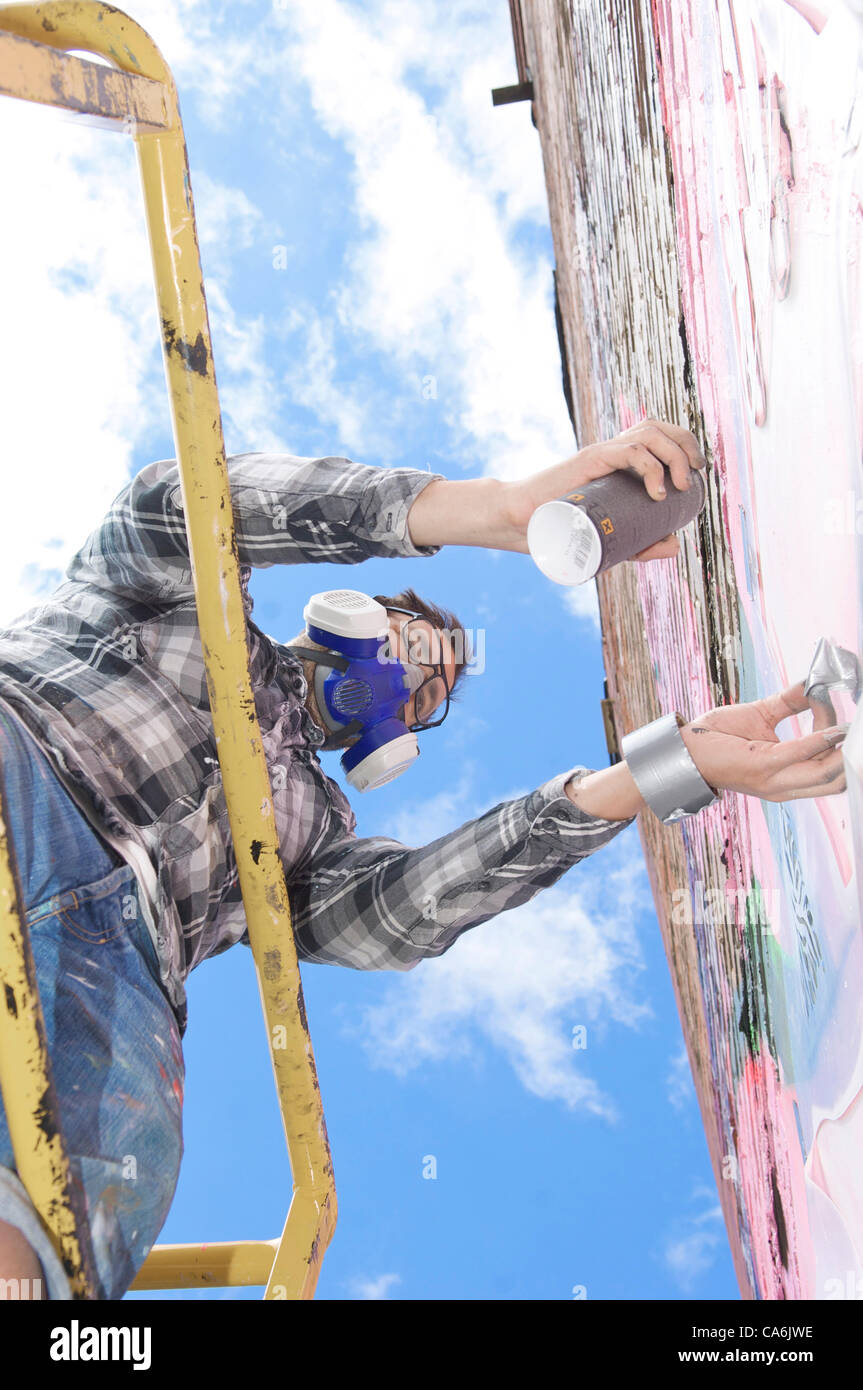 Second annual Sand Sea and Spray urban arts festival in Blackpool,UK featuring 43 street artists from all over the world.Artist Janus working on a building. Stock Photo