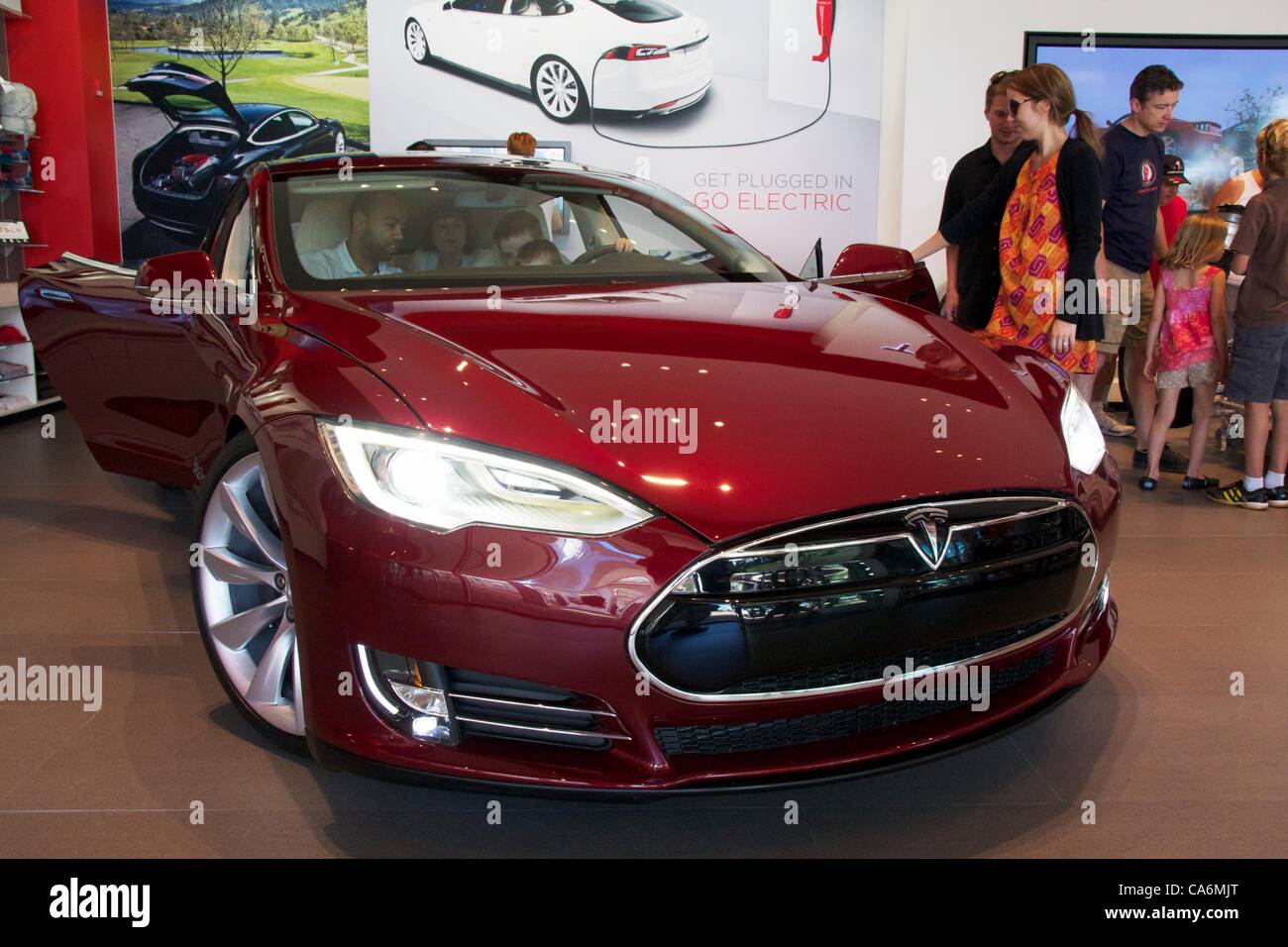 17, June, 2012, Oak Brook, Illinois, USA. Prospective customers consider the new Tesla Motors Model S. The Model S, an all electric car, with up to a 300 mile range and under 6 second 0-60 mph acceleration, goes on sale this month. Stock Photo