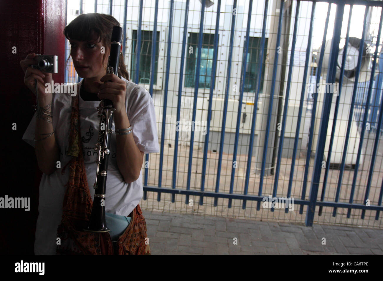 June 18, 2012 - Ramallah, West Bank - A musician takes a photo as Palestinian, Israeli and foreign musicians band together to play during their presentation at the Qalandia checkpoint between Jerusalem and Ramallah. (Credit Image: © Issam Rimawi/APA Images/ZUMAPRESS.com) Stock Photo