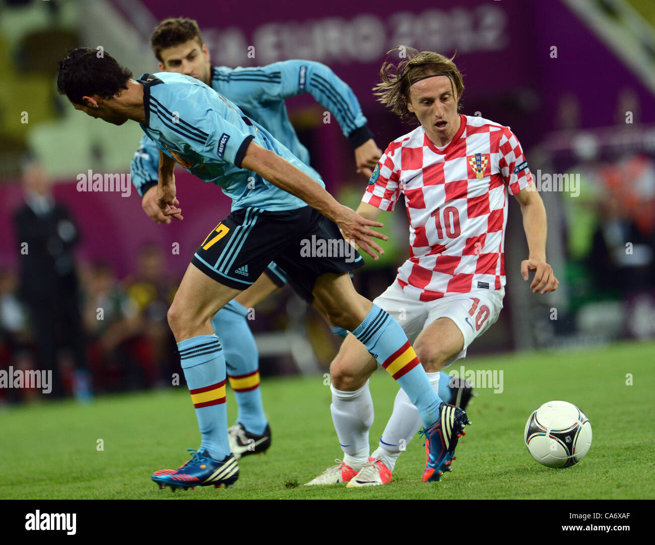 18.06.2012. Gdansk, Poland.  Croatia's Luka Modric (R-L) vies for the ball with Spain's Gerard Pique and Alvaro Arbeloa during UEFA EURO 2012 group C soccer match Croatia vs Spain at Arena Gdansk in Gdansk, Poland, 18 June 2012. Stock Photo