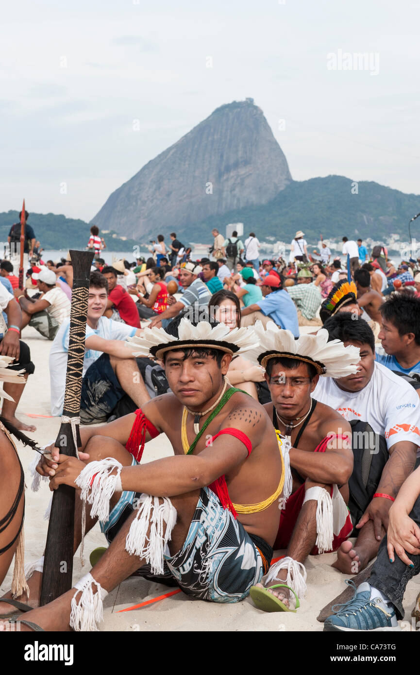 Indigenous people and others are assembling the human banner on Flamengo beach to protest about the construction of hydroelectric dams on Brazil's rivers with the Sugarloaf in the background. The People's Summit at the United Nations Conference on Sustainable Development (Rio+20), Rio de Janeiro, Brazil, 19th June 2012. Photo © Sue Cunningham. Stock Photo