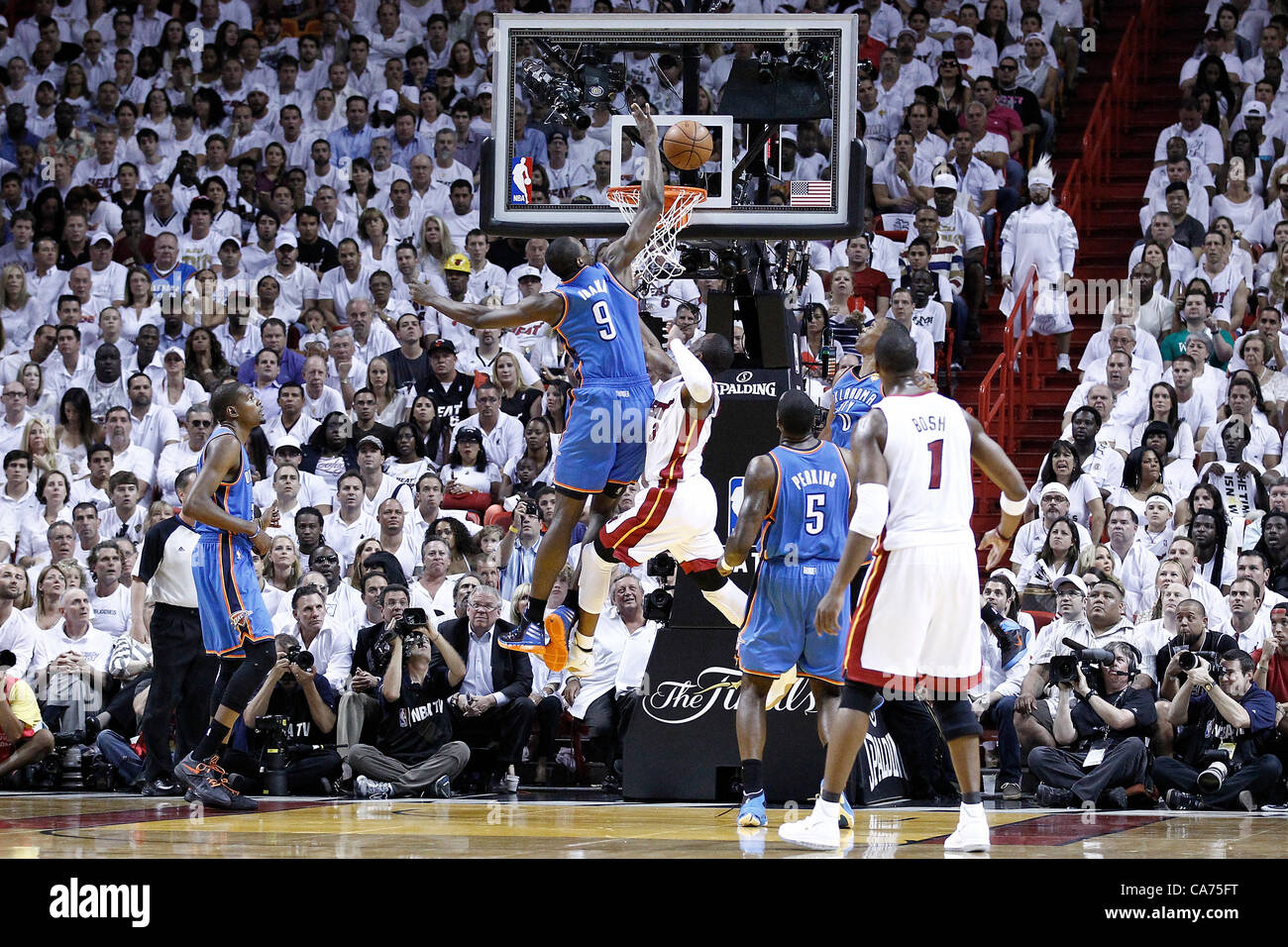 19.06.2012. Miami, Florida, USA.  Miami Heat shooting guard Dwyane Wade (3) is fouled by Oklahoma City Thunder power forward Serge Ibaka (9) during the first quarter of Game 4 of the 2012 NBA Finals, Thunder at Heat, at the American Airlines Arena, Miami, Florida, USA. Stock Photo
