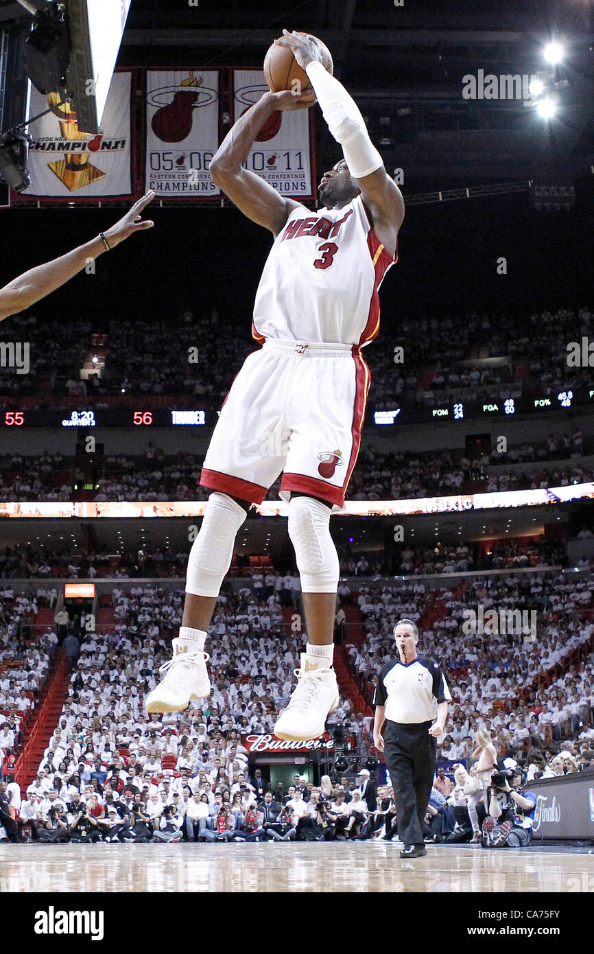 19.06.2012. Miami, Florida, USA. Oklahoma City Thunder point guard Russell  Westbrook (0) takes a jumpshot over Miami Heat shooting guard Dwyane Wade  (3) during the first quarter of Game 4 of the