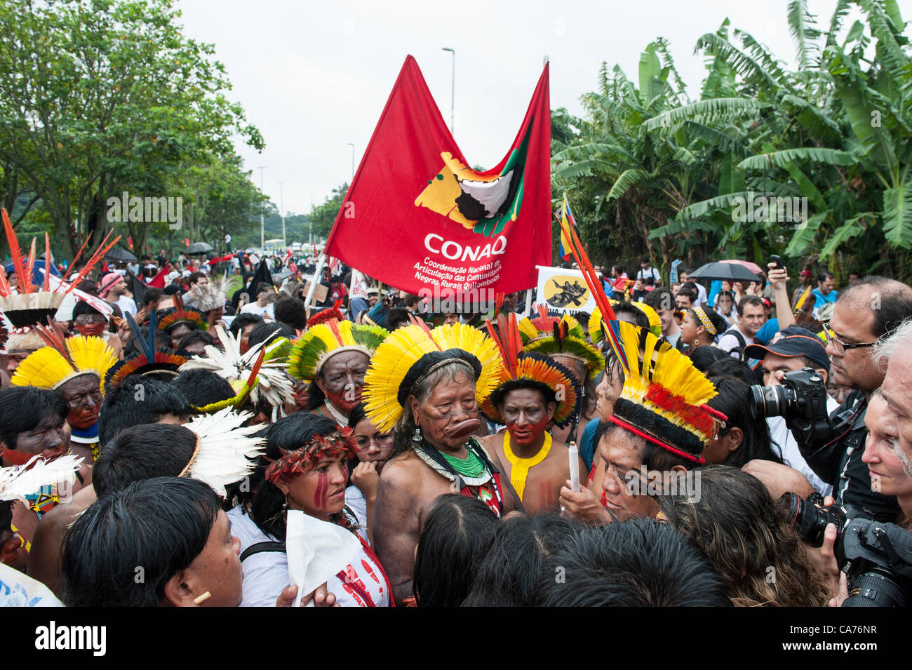 Kayapo Chief Raoni Metuktire, indigenous leaders Sheyla Juruna and Tabata Kuikuro and other indigenous leaders march at a demonstration by indigenous people, the Landless People's Movement (MST) and other civil society groups in front of the Riocentro United Nations conference. The demonstrators wanting to hand in a petition against the building of dams in the Amazon, are kept out of earshot and invisible to the UN conference. The United Nations Conference on Sustainable Development (Rio+20), Rio de Janeiro, Brazil, 20th June 2012. Photo © Sue Cunningham. Stock Photo
