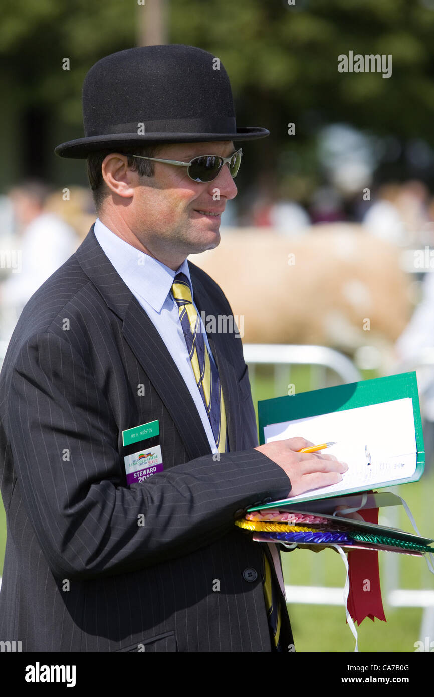 Lincolnshire Events Centre, UK, 20th June 2012. A steward enjoying the sunshine in one of the livestock rings on the opening day of the 2012 Lincolnshire Show Stock Photo