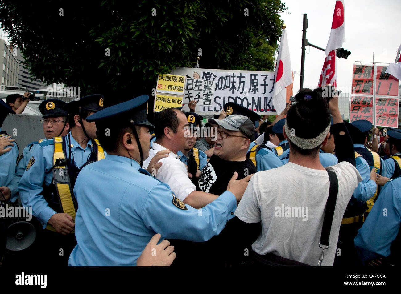 June 22, 2012, Tokyo, Japan - Group for power plants in Japan faces nuclear demonstrators during a demo to protest restarting Oi plant. Anti-nuclear protesters stage a Twitter organized rally in front of the Prime Minister's Official Residence opposing the reactivation of the Oi Nuclear Power Plant in Fukui Prefecture. Stock Photo