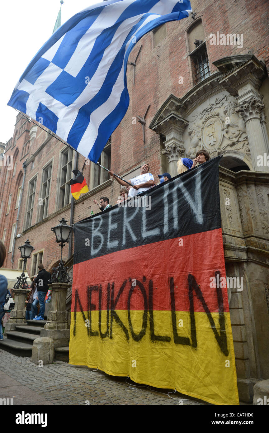 22.06.2012. Gdansk, Poland.  Supporters of Greece wave the Greek flag over the German flag in the streets prior to the UEFA EURO 2012 quarter-final soccer match Germany vs Greece at Arena Gdansk in Gdansk, Poland, 22 June 2012. Stock Photo