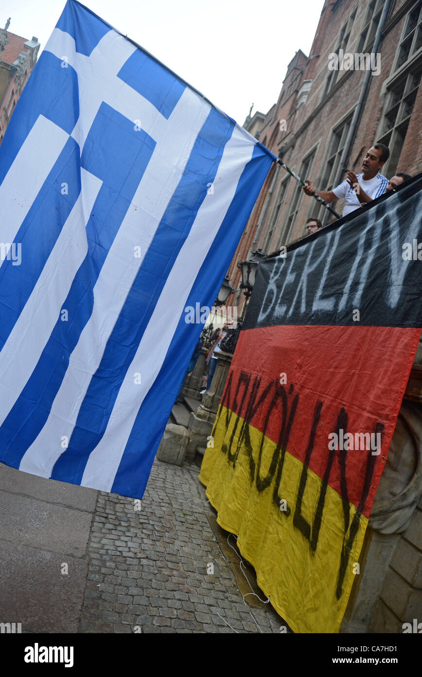 22.06.2012. Gdansk, Poland. Supporters of Greece wave the Greek flag over the German flag in the streets prior to the UEFA EURO 2012 quarter-final soccer match Germany vs Greece at Arena Gdansk in Gdansk, Poland, 22 June 2012.  Stock Photo