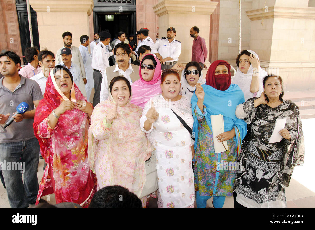 Pakistan Muslim League (N) members of Punjab Assembly  chant slogans against Opposition member Samina Khawar Hayat during protest demonstration at  Punjab assembly in Lahore on Friday, June 22, 2012. Stock Photo