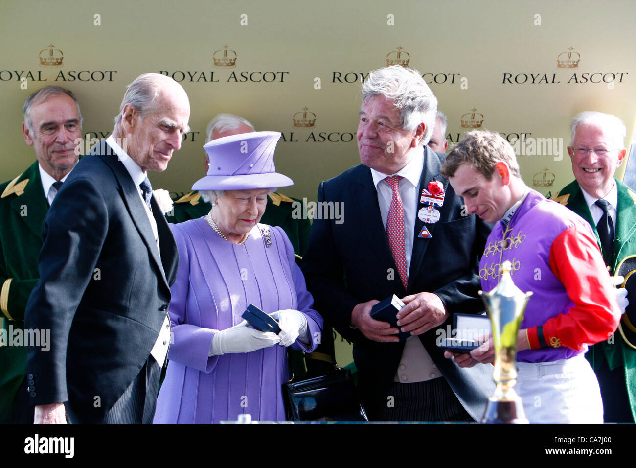 22.06.12 Ascot, Windsor, ENGLAND:  Prince Philip, Duke of Edinburgh presents the Trophy to Queen Elizabeth II as the owner with Sir Michael Stoute and Jockey Ryan Moore The Queens Vase during Royal Ascot Festival at Ascot racecourse on June 22, 2012 in Ascot, England. Stock Photo