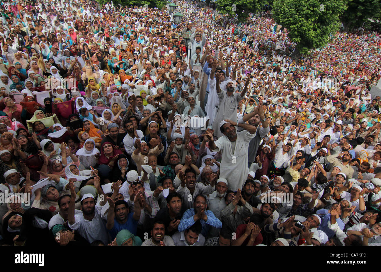 Kashmiri Muslim devotees raise their hands for prayers as a relic of Prophet Muhammad is displayed on the Friday following at the Hazratbal Shrine on the outskirts of Srinagar, the summer capiatl of indian kashmir  on 22,6, 2012 .Devotees thronged to the Hazratbal Shrine on the following Friday of the Muslim festival Mehraj-u-Alam, believed to mark the ascension of Prophet Mohammed to Heaven.  Photo/Altaf Zargar/Zuma Press Stock Photo