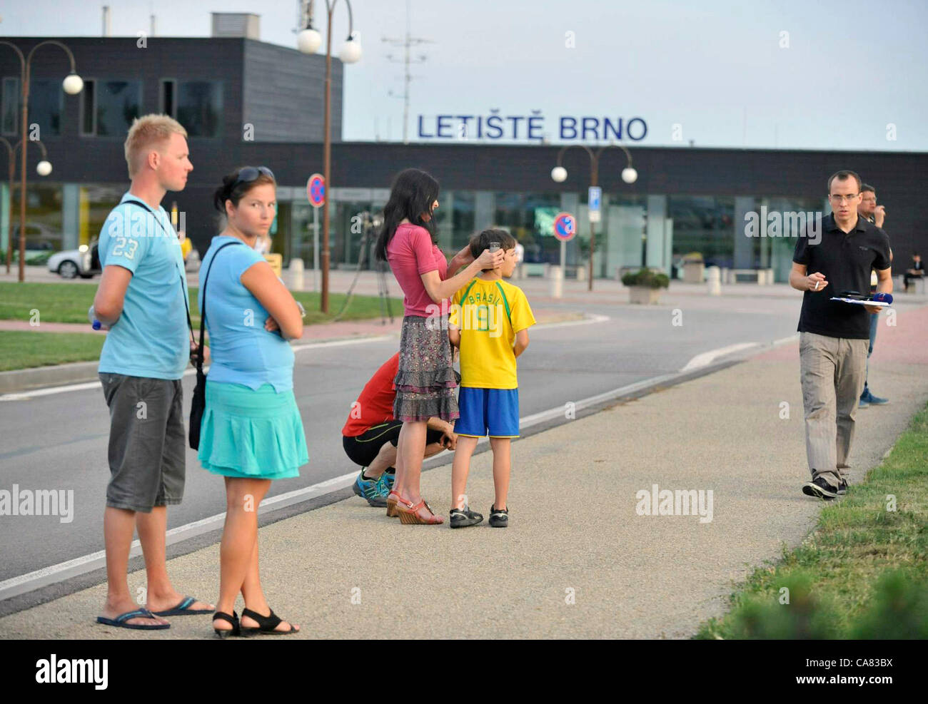 People wait for the the Airplane of the Czech Air Force with the Czech tourists who crashed with the bus in Croatia, landed in Brno, Czech Republic shortly before 8 PM on June 24, 2012. The bus with Czech tourists crashed near Gospic, Croatia, Saturday, June 23, 2012. Eight tourists were killed and 51 injured in a bus crash on a major highway in Croatia early Saturday, police said. The accident happened some 200 kilometers (124 miles) south of Zagreb, on the highway connecting the Croatian capital with the central Adriatic coastal city of Split. (CTK Photo/Vaclav Salek) Stock Photo
