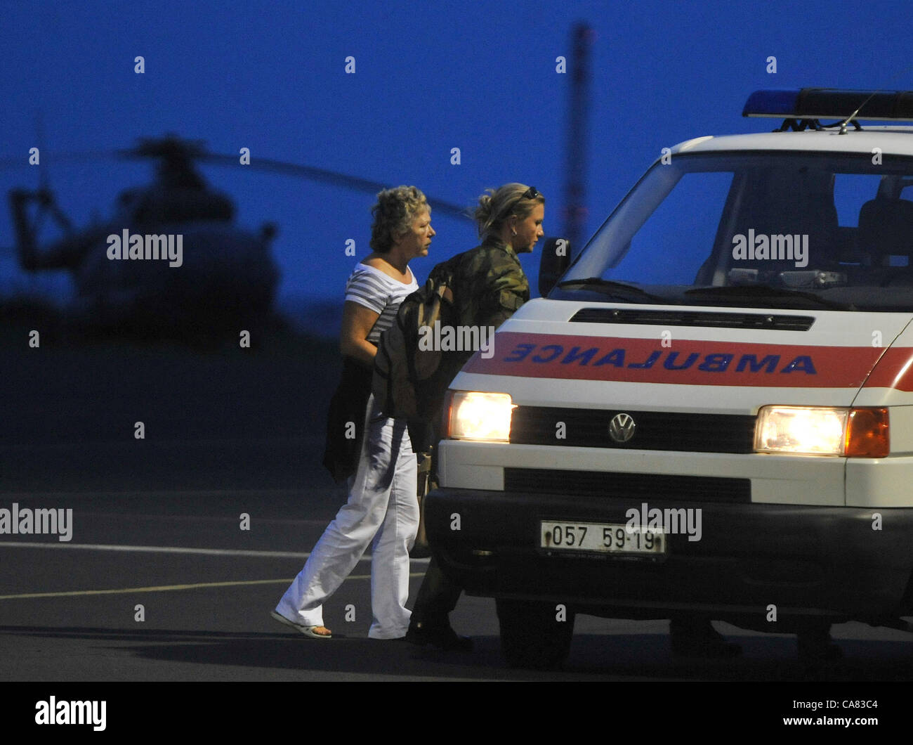 The Airplane of the Czech Air Force with the Czech tourists who crashed with the bus in Croatia, landed in Brno, Czech Republic on June 24, 2012. The ambulance cars transport the injured. The bus with Czech tourists crashed near Gospic, Croatia, Saturday, June 23, 2012. Eight tourists were killed and 51 injured in a bus crash on a major highway in Croatia early Saturday, police said. The accident happened some 200 kilometers (124 miles) south of Zagreb, on the highway connecting the Croatian capital with the central Adriatic coastal city of Split. (CTK Photo/Stanislav Peska) Stock Photo