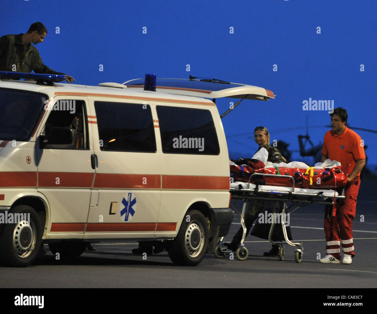 The Airplane of the Czech Air Force with the Czech tourists who crashed with the bus in Croatia, landed in Brno, Czech Republic on June 24, 2012. The ambulance cars transport the injured. The bus with Czech tourists crashed near Gospic, Croatia, Saturday, June 23, 2012. Eight tourists were killed and 51 injured in a bus crash on a major highway in Croatia early Saturday, police said. The accident happened some 200 kilometers (124 miles) south of Zagreb, on the highway connecting the Croatian capital with the central Adriatic coastal city of Split. (CTK Photo/Stanislav Peska) Stock Photo