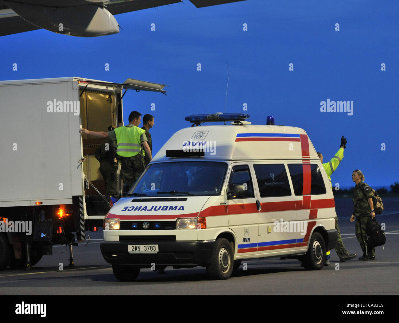 The Airplane of the Czech Air Force with the Czech tourists who crashed with the bus in Croatia, landed in Brno, Czech Republic on June 24, 2012. The ambulance cars transport the injured. The bus with Czech tourists crashed near Gospic, Croatia, Saturday, June 23, 2012. Eight tourists were killed and 51 injured in a bus crash on a major highway in Croatia early Saturday, police said. The accident happened some 200 kilometers (124 miles) south of Zagreb, on the highway connecting the Croatian capital with the central Adriatic coastal city of Split. (CTK Photo/Stanislav Peska) Stock Photo