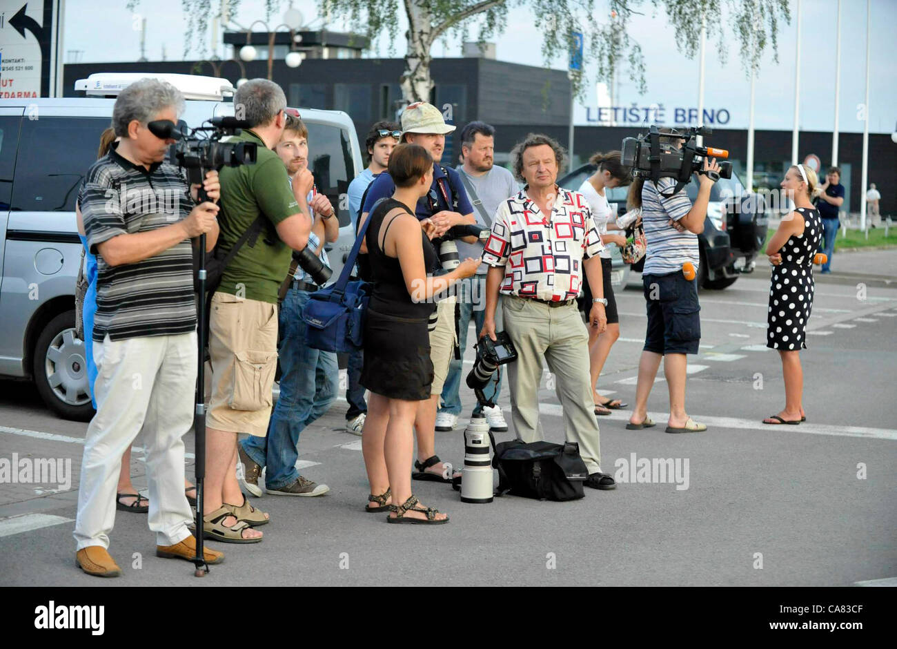 Journalists wait for the the Airplane of the Czech Air Force with the Czech tourists who crashed with the bus in Croatia, landed in Brno, Czech Republic shortly before 8 PM on June 24, 2012. The bus with Czech tourists crashed near Gospic, Croatia, Saturday, June 23, 2012. Eight tourists were killed and 51 injured in a bus crash on a major highway in Croatia early Saturday, police said. The accident happened some 200 kilometers (124 miles) south of Zagreb, on the highway connecting the Croatian capital with the central Adriatic coastal city of Split. (CTK Photo/Vaclav Salek) Stock Photo