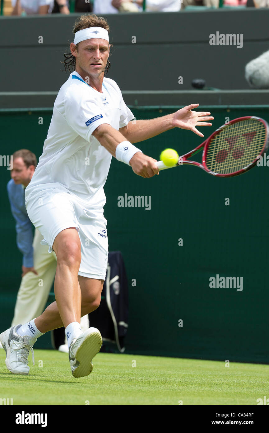 25.06.2012 London, England David Nalbandian of Argentina  in action against Janko Tipsarevic of Serbia  during the first round of the match at Wimbledon Tennis Championships at The All England Lawn Tennis Club. Stock Photo