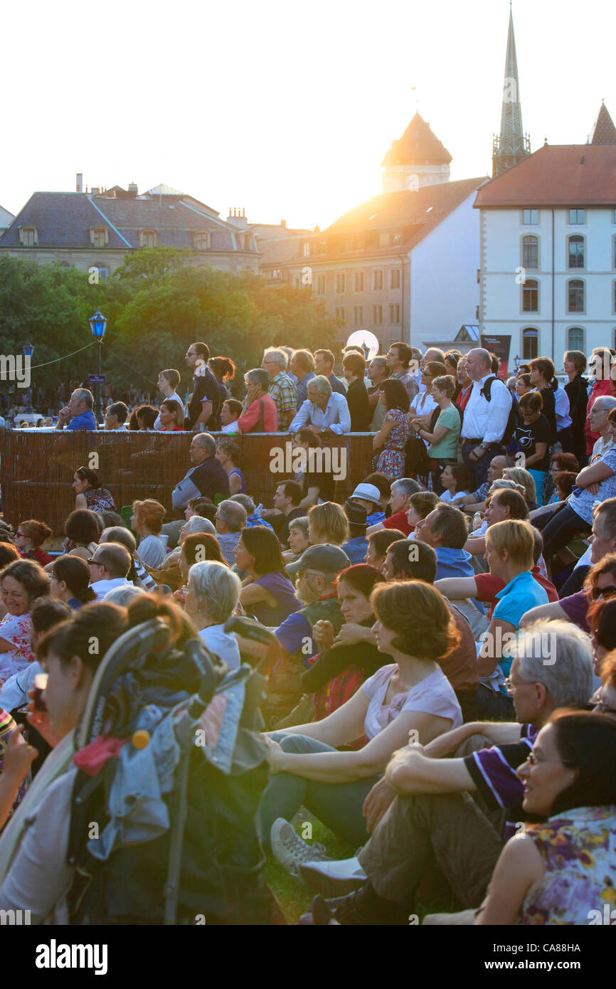 Visitors enjoying free performance in downtown Geneva city at sunset  during traditional summer open air music festival Fête de la Musique in Geneva, Switzerland Stock Photo