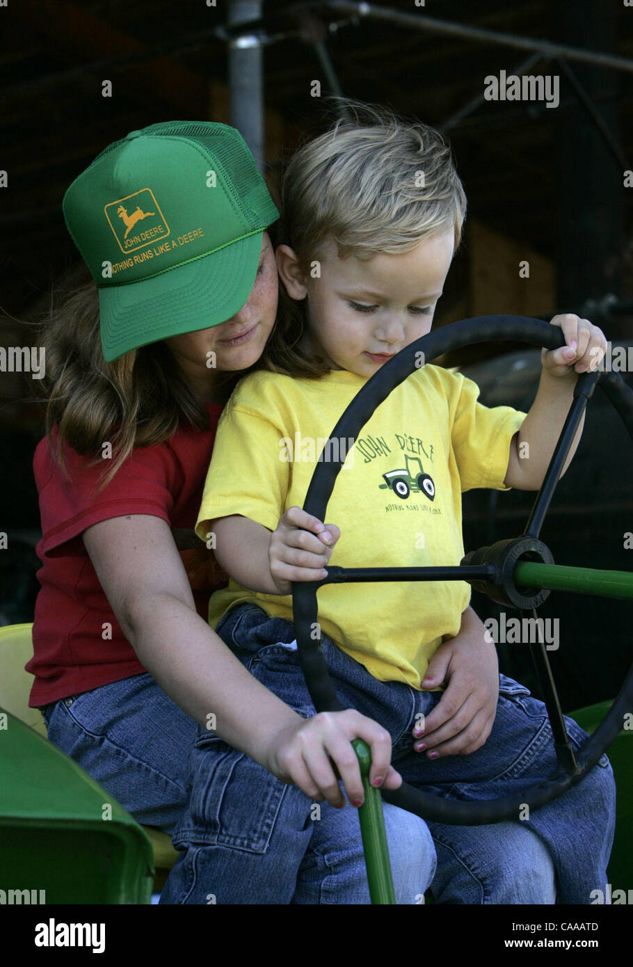 Stephanie Cheesman(cq), left, 11 and brother Cole Cheesman(cq), 2, play on their father's 1940 Model A John Deere tractor during the Antique Gas and Steam Engine Museum Summer Harvest Fair in Vista, CA.  The family is from Yucaipa, CA.  UT/John Gastaldo Stock Photo